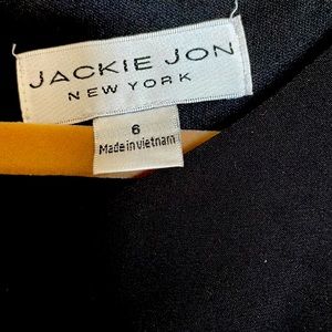 Black cocktail dress. Rhinestone embellishments.  Sheath.